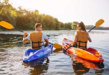 Two people kayaking on a sunny river