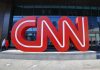 Large red CNN sign outside building entrance