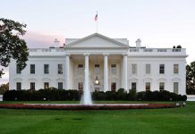 The White House with fountain and American flag