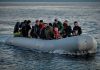 People on a packed raft in open water