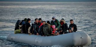 People on a packed raft in open water
