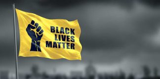 Yellow Black Lives Matter flag with clenched fist