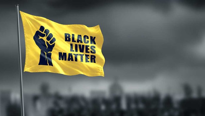 1756895792 featured image Yellow Black Lives Matter flag with clenched fist