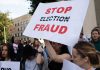 People holding Stop Election Fraud protest signs