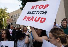People holding Stop Election Fraud protest signs
