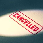 Red Cancelled stamp under a spotlight