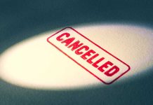 Red Cancelled stamp under a spotlight