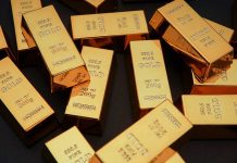 Gold bars stacked on dark background