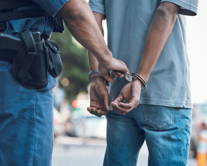 2337392319 featured image Police officer handcuffing a person outdoors
