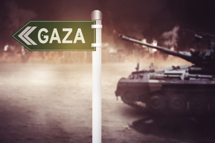 2394842837 featured image Sign pointing to Gaza with tank nearby
