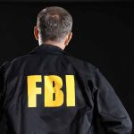 Person wearing jacket with FBI printed on back