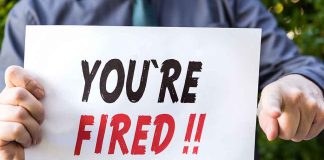 Person holding YOU ARE FIRED sign