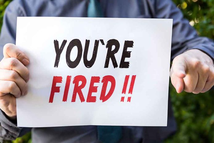 388134190 featured image Person holding YOU ARE FIRED sign
