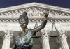 Lady Justice statue in front of courthouse