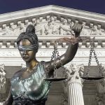 Lady Justice statue in front of courthouse