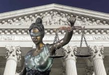 Lady Justice statue in front of courthouse