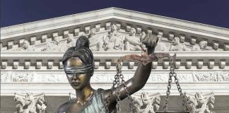 Lady Justice statue in front of courthouse