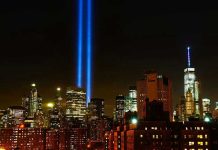 New York City skyline at night with memorial lights