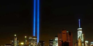 New York City skyline at night with memorial lights