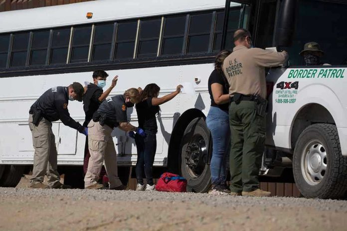 Border patrol officers investigating people near a bus
