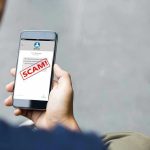 Person reading a scam message on a smartphone