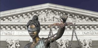 Lady Justice statue in front of courthouse