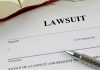 Lawsuit document with a pen and book