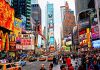 Times Square crowded with people and bright electronic advertisements