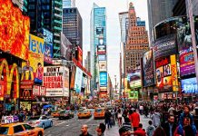 Times Square crowded with people and bright electronic advertisements
