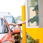 Customer receiving a food order at a drive thru window