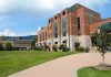 Modern educational building on a college campus with landscaped grounds