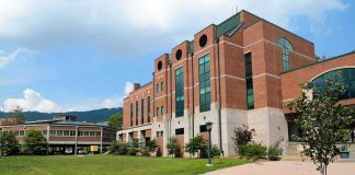 Modern educational building on a college campus with landscaped grounds