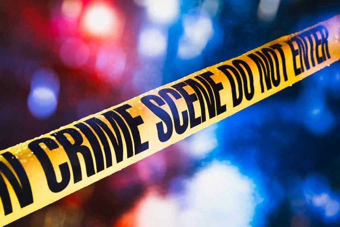 Yellow crime scene tape with blurred lights background.