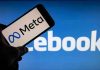 Meta on phone screen, Facebook in background.