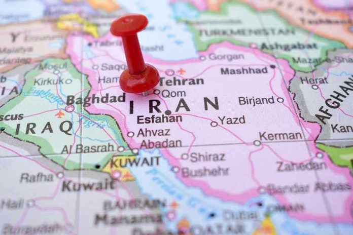 Red pushpin marking Iran on a map