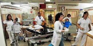 Medical staff attending to patients in a busy hospital emergency room