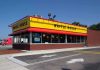 Exterior view of a Waffle House restaurant with bright yellow signage