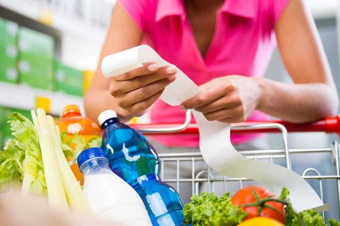 Person examining a receipt while shopping for groceries
