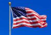 Waving American flag against a clear blue sky