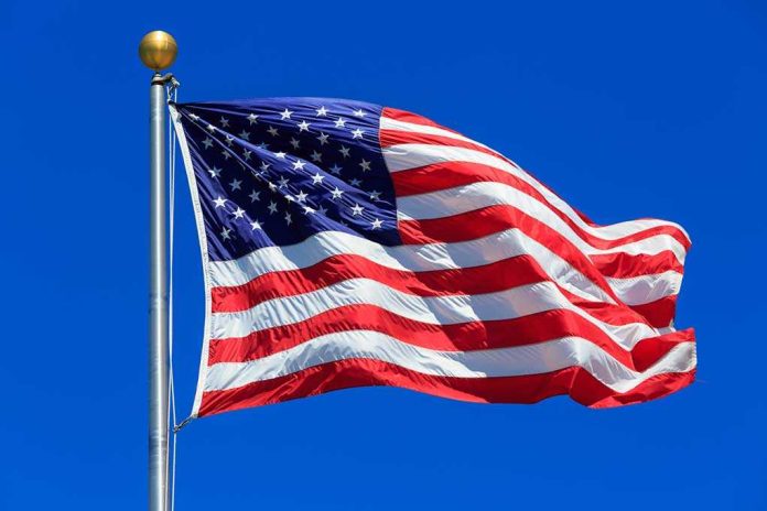 shutterstock_442392457 (1).jpg Waving American flag against a clear blue sky