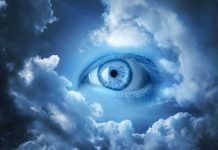 A large blue eye emerging from a cloudy sky