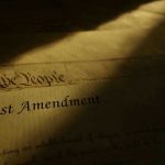 1st Amendment document in dramatic lighting.