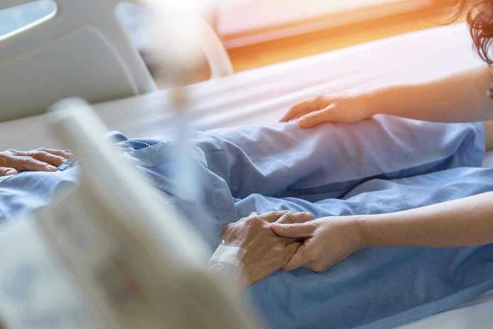 1921764251 Hospital patient holding visitors hand reassuringly.