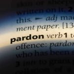 Trump Pardons Billionaire Bro — Nation Stunned The word pardon highlighted in a dictionary.
