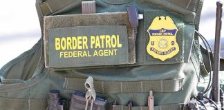 Feds WARN State: Hands Off Our Agents Border Patrol vest with gear and communication equipment.