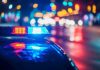 Airport Attack Intercepted – Feds Swoop In! Police car with flashing lights at night.
