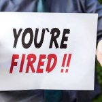 CORPORATE Bloodbath: 16,000 Jobs Axed Overnight! Person holding YOURE FIRED sign.