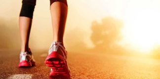 Person jogging on a road during sunrise
