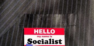 ANOTHER Socialist Mayor Elected – Wins By 97 Votes! Hello my name is Socialist name tag on suit.
