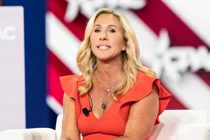 Woman speaking at an event, wearing a red dress.